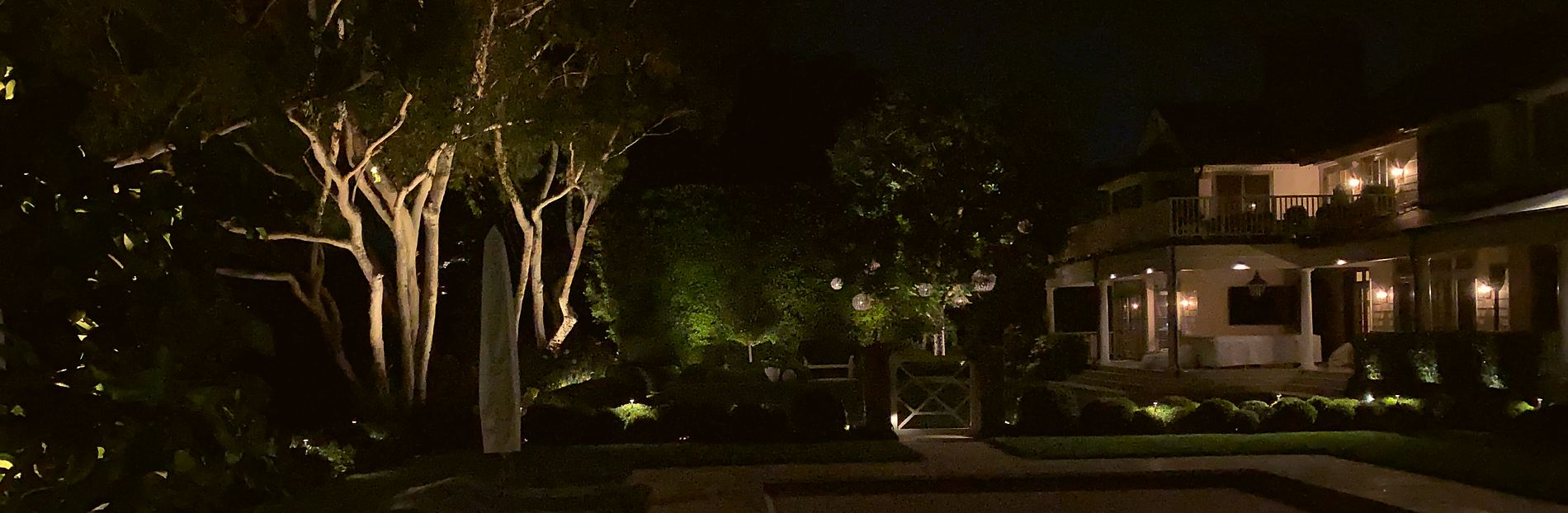 An outdoor fireplace lounge lit at night