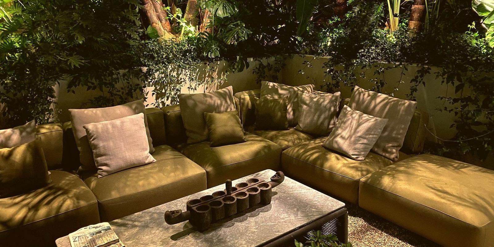 A lush garden terrace lit warm at night