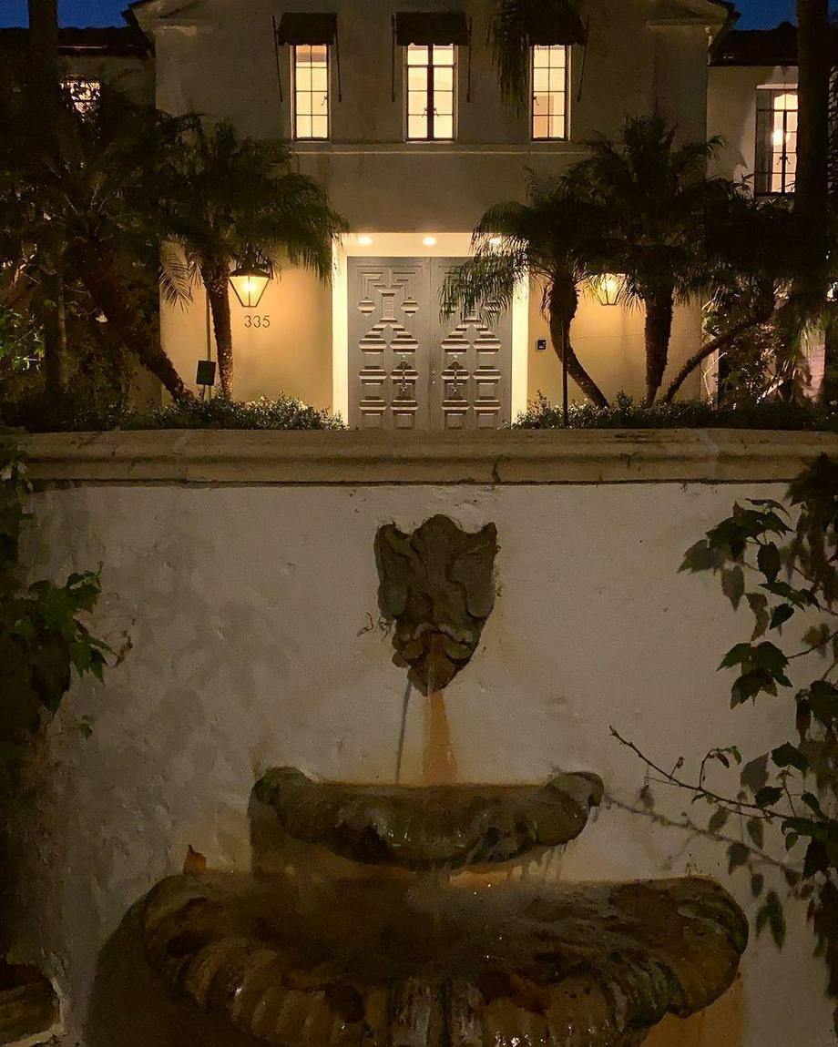 A stone fountain wall lit at night