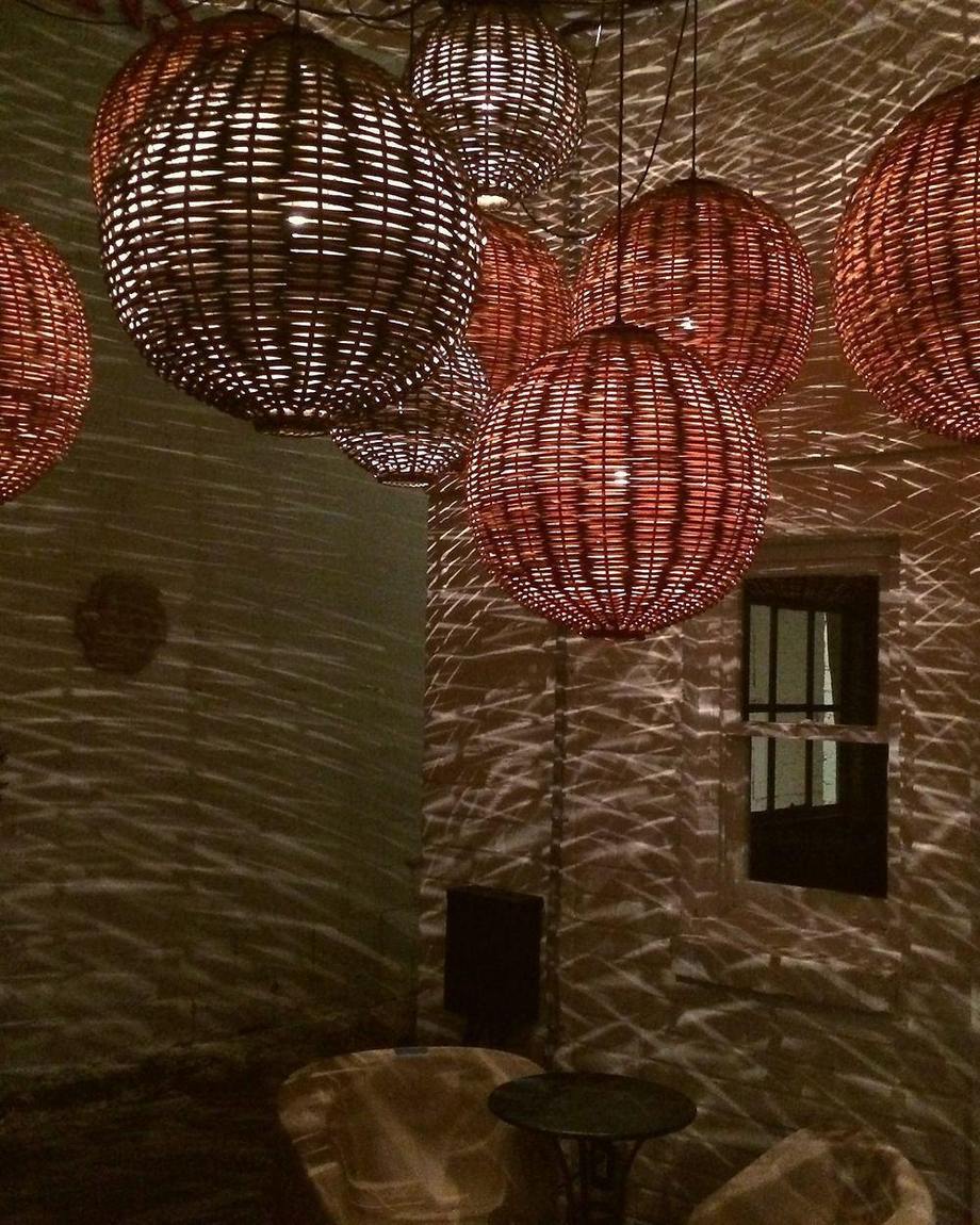 Custom woven pendants lit on a terrace