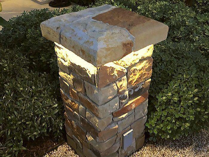 A stone pillar lit at night