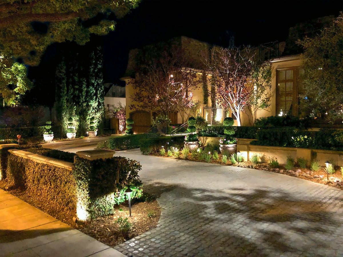 Lit estate facade above terraced