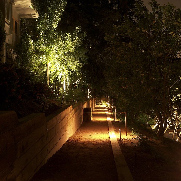 A warm low-voltage lighting system along a garden path