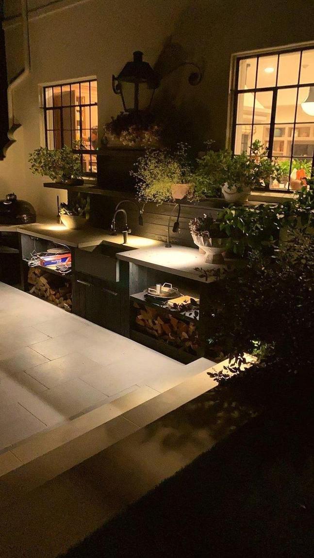 An outdoor kitchen and a fountain wall.