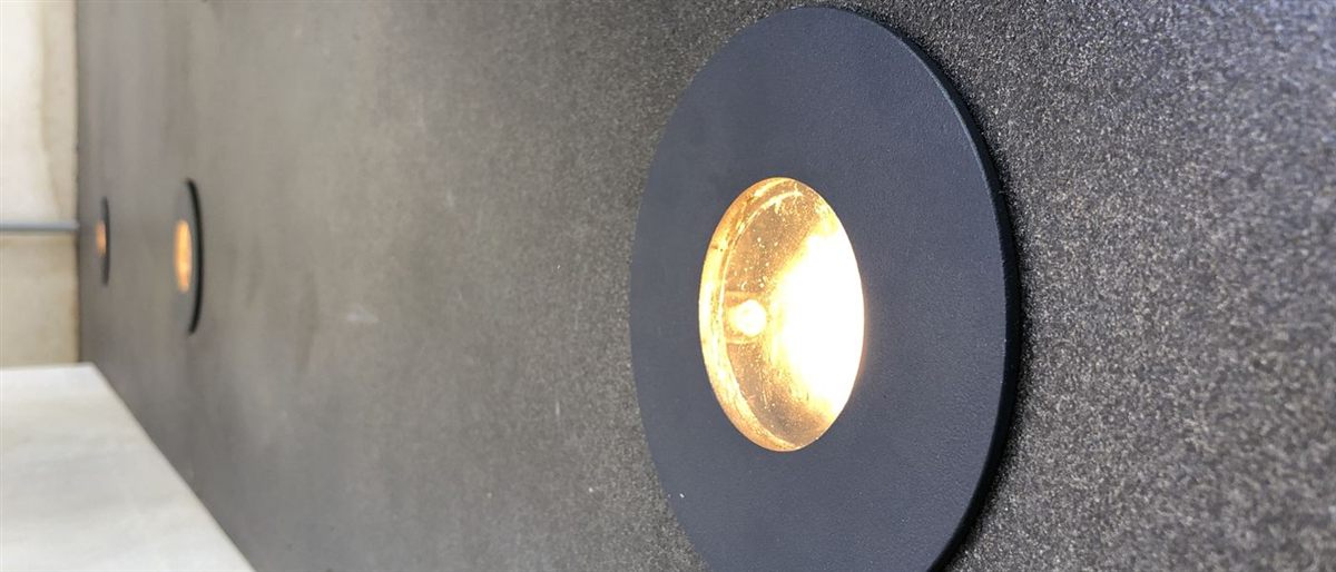 A round recessed wall light, close up