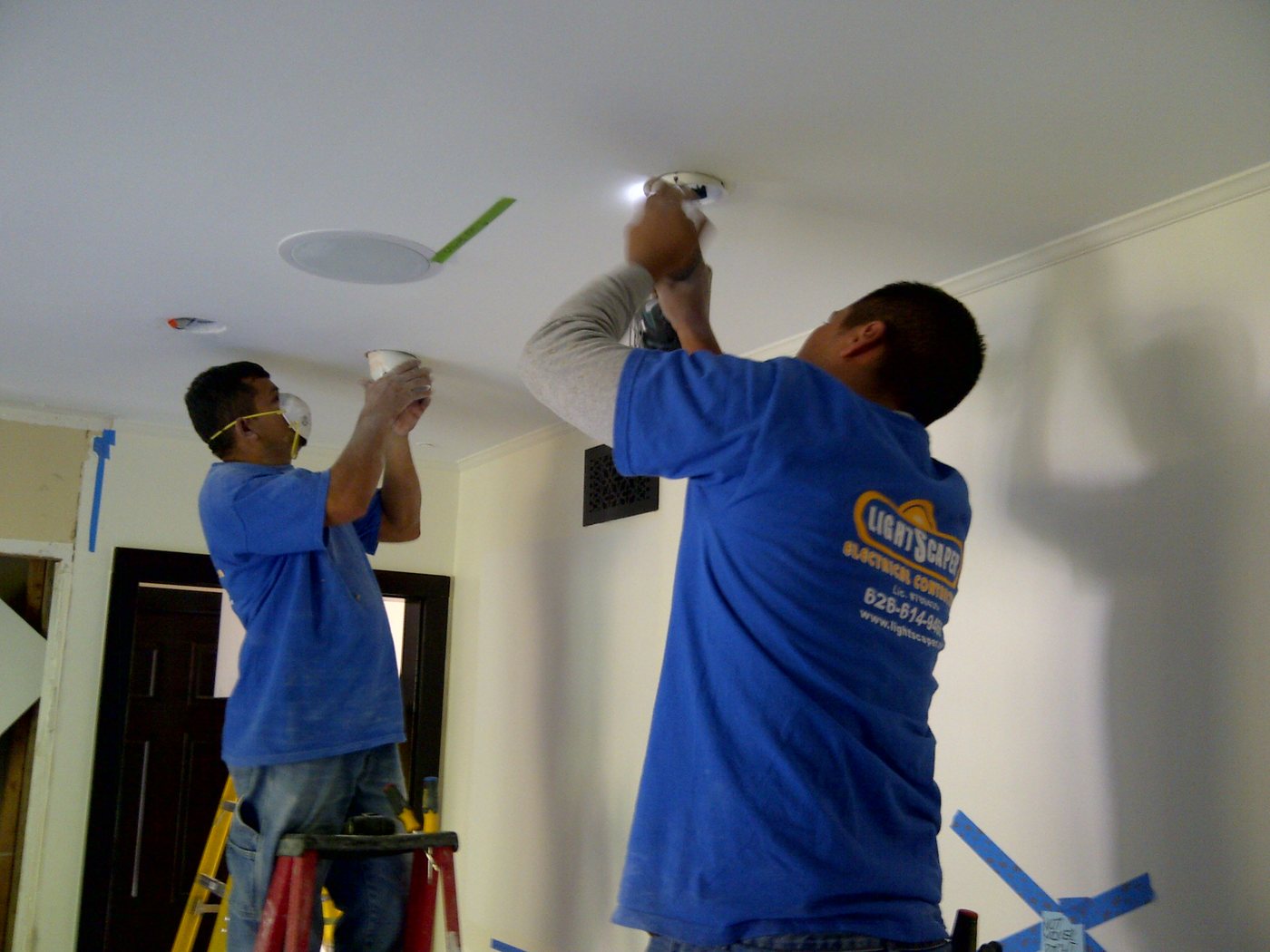 Installers setting recessed ceiling lights